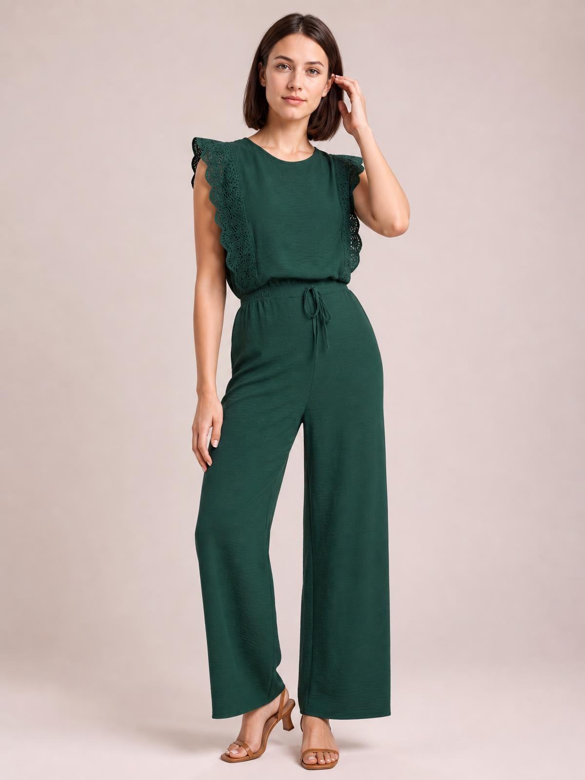 A model poses in a dark green lace-trim round-neck top and wide-leg pants set, featuring lace sleeves and a tied waist.