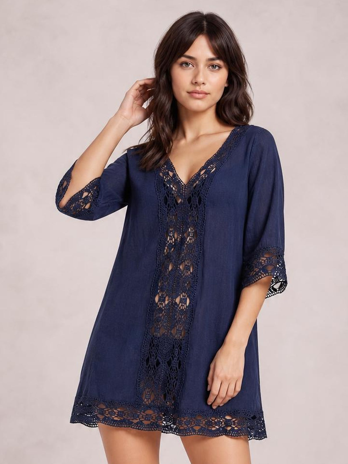 Model poses with one hand in her hair wearing a navy Lace Trim V-Neck Cover-Up with a relaxed A-line silhouette, three-quarter sleeves, and lace panel detailing.