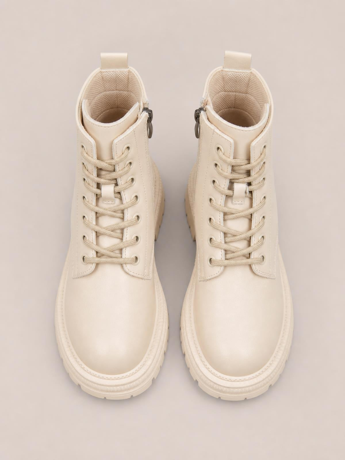 Cream PU leather lace-up platform boots with rounded toes, padded collars, side zippers, and chunky low heels with textured rubber soles.