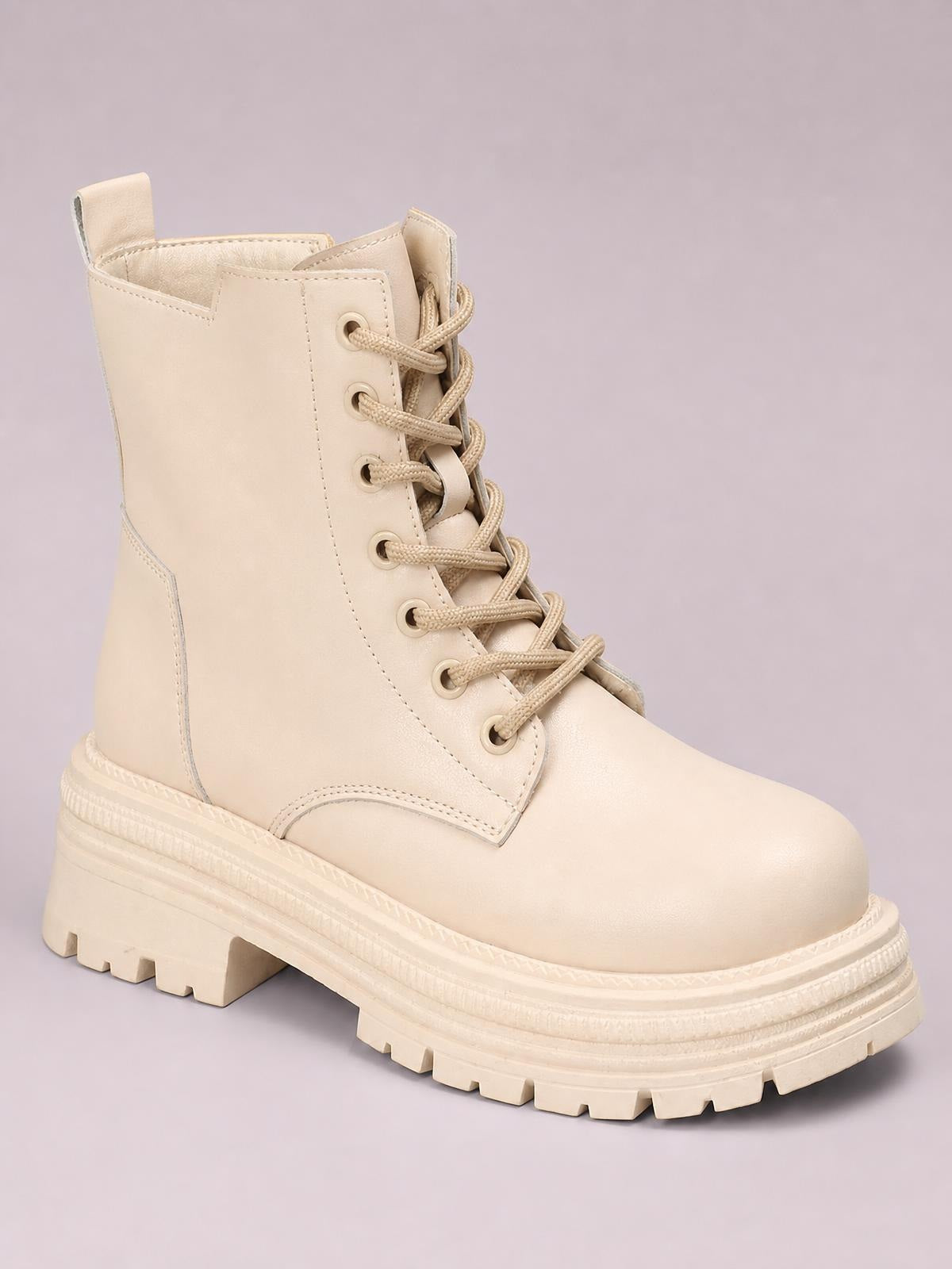 A cream PU leather lace-up platform boot features a rounded toe, tall structured shaft, tonal stitching, and a chunky lugged rubber sole.