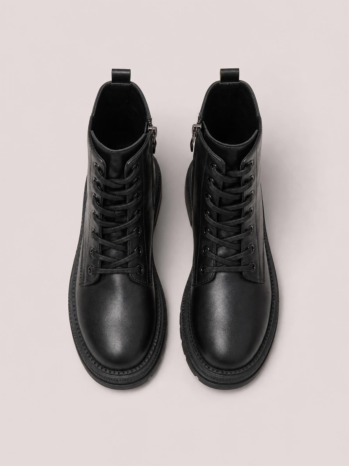 Black PU leather lace-up platform boots with rounded toes, low heels, thick rubber soles, pull tabs, and visible side zippers.