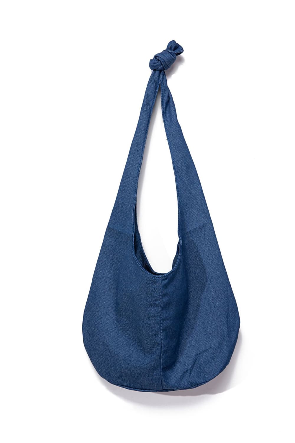 Large blue canvas crossbody bag with a softly rounded, roomy silhouette, elongated strap, and gathered knotted detail at the top.