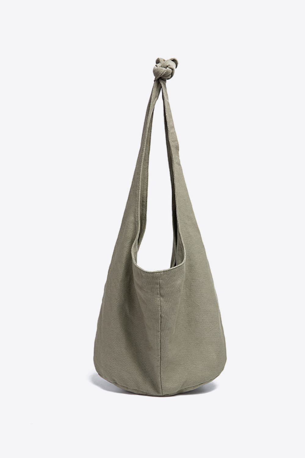 Large olive-gray canvas crossbody bag with a softly rounded, slouchy silhouette, elongated strap, gathered knotted top, and central stitched seam.