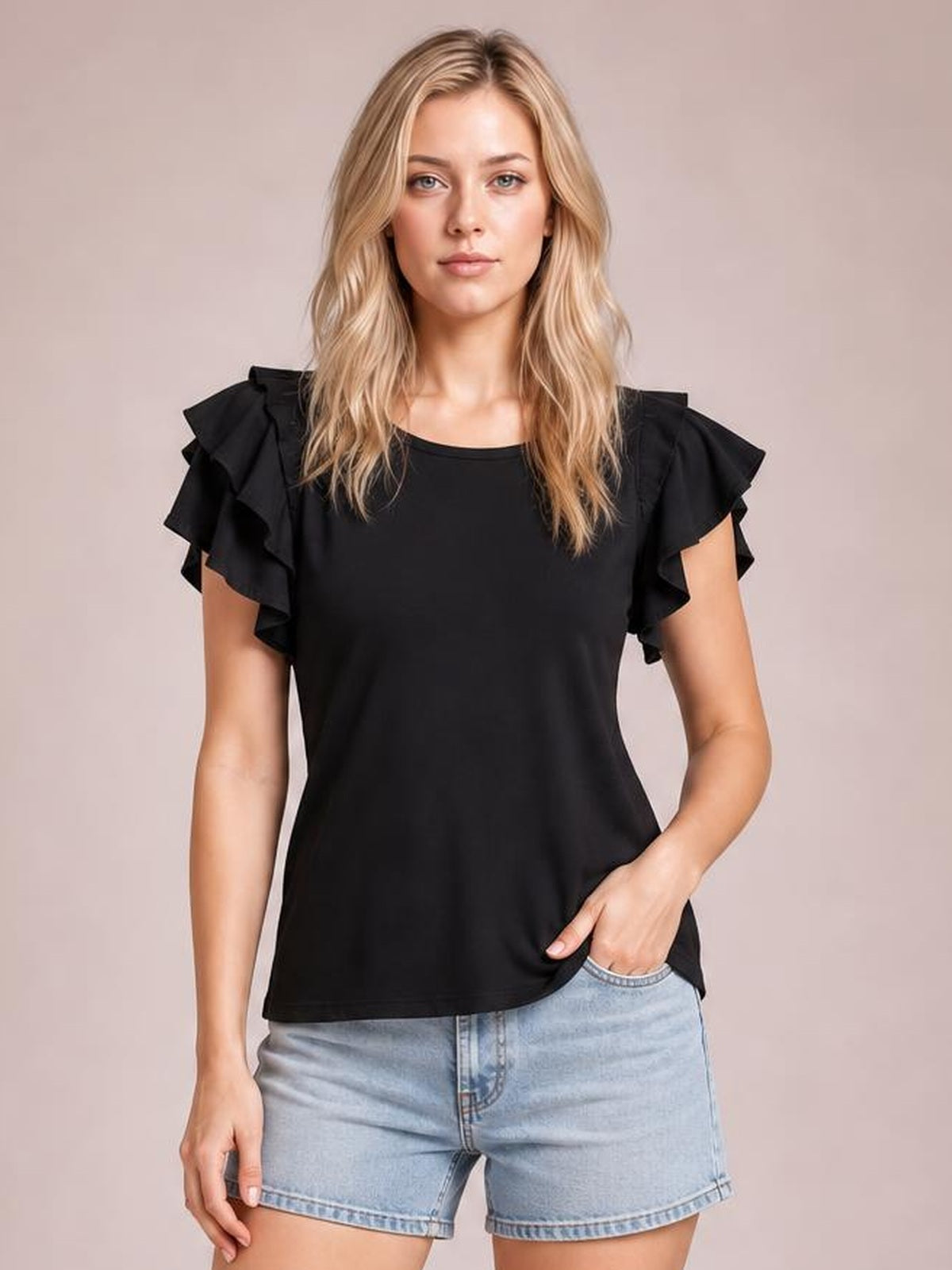 Model in a relaxed pose wears a solid black layered flutter sleeve round neck top with a regular-length silhouette and ruffled short sleeves.