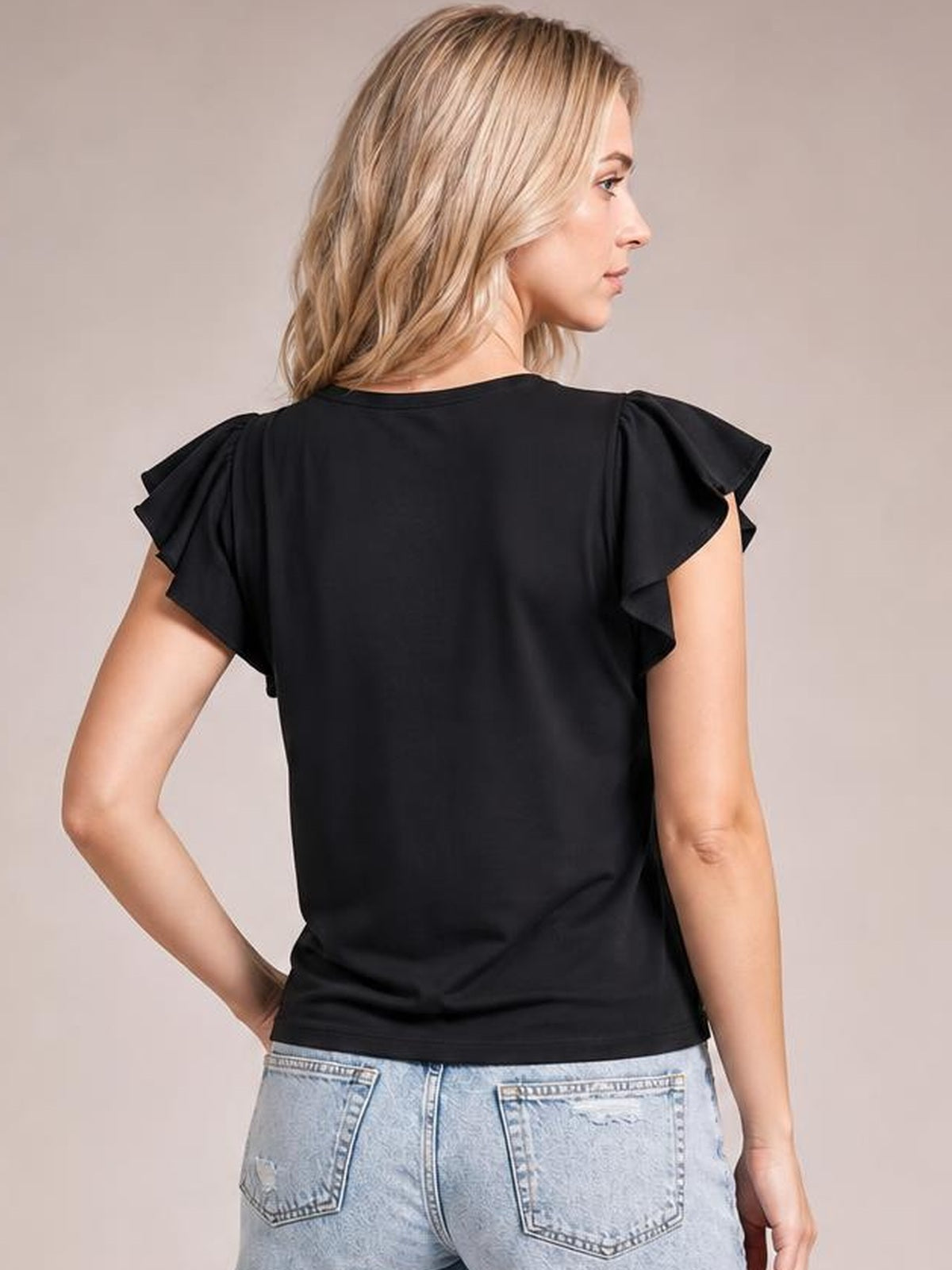 A model poses from the back in a solid black layered top with a round neck, flowing flutter sleeves, and a relaxed regular silhouette.