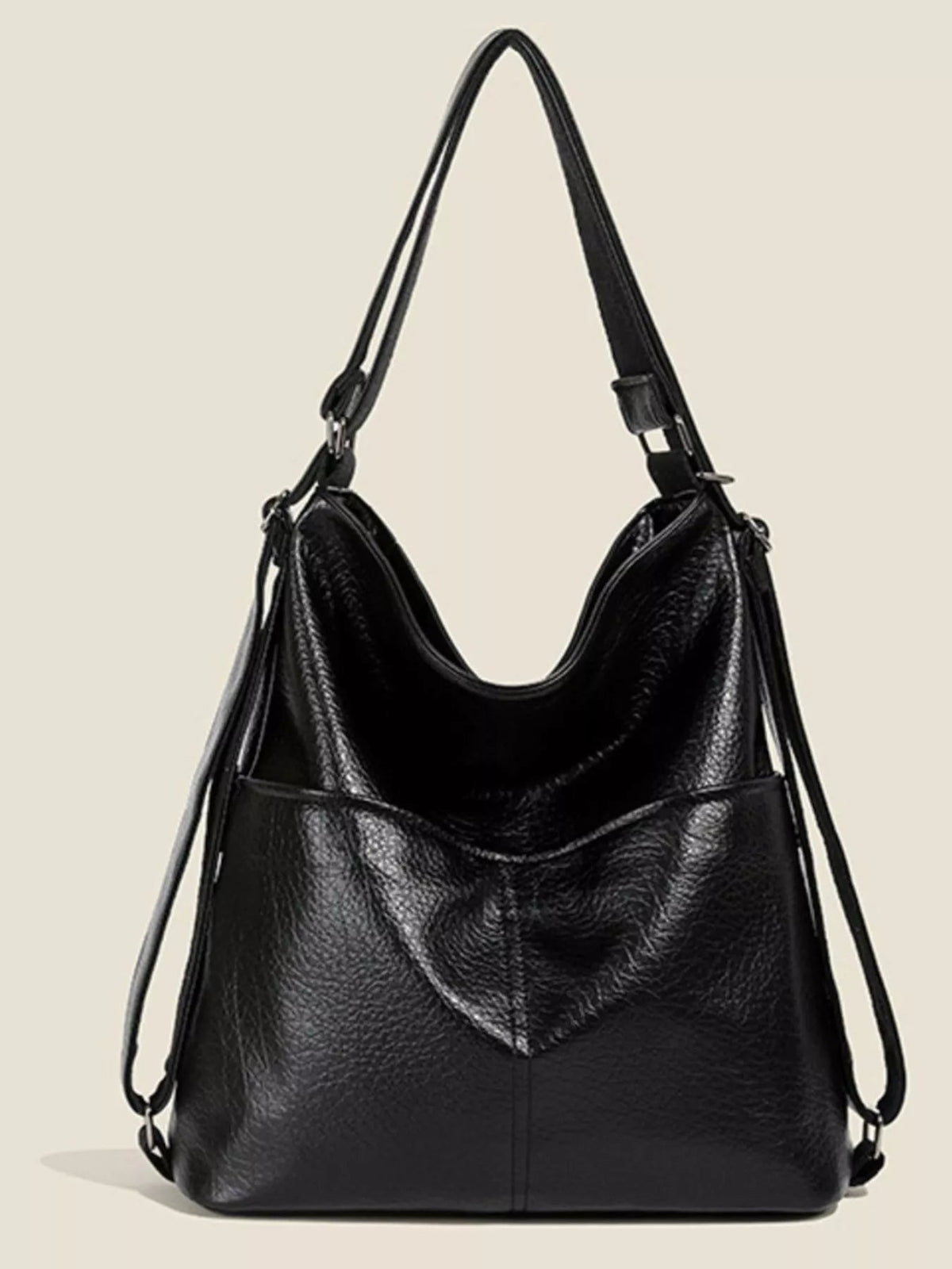Black medium convertible shoulder bag in textured PU leather, featuring a slouchy silhouette, adjustable straps, metal hardware, and a stitched front pocket.