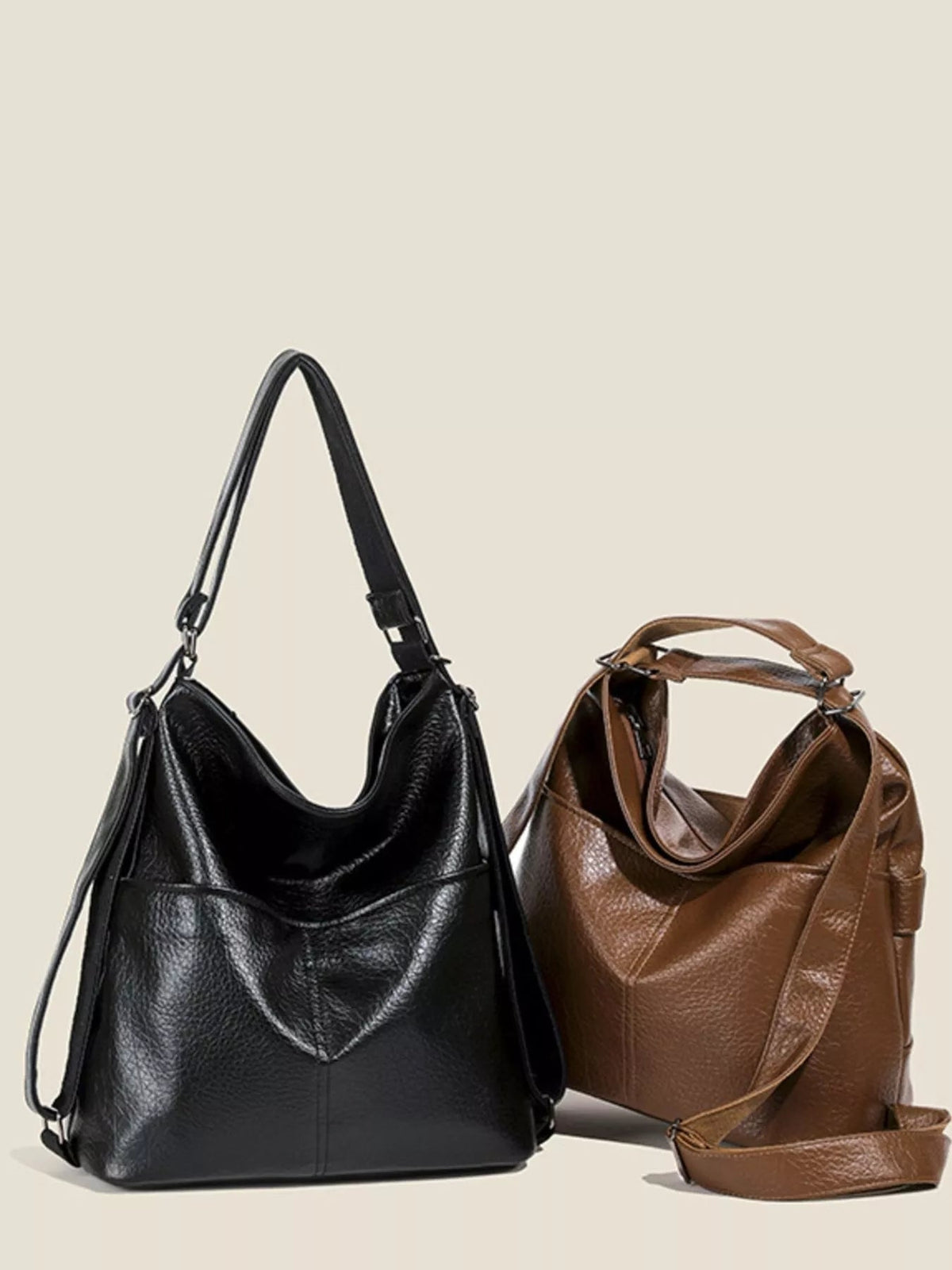A medium black PU leather convertible shoulder bag features a slouchy silhouette, top handle, adjustable strap, and matching brown variation displayed beside it.