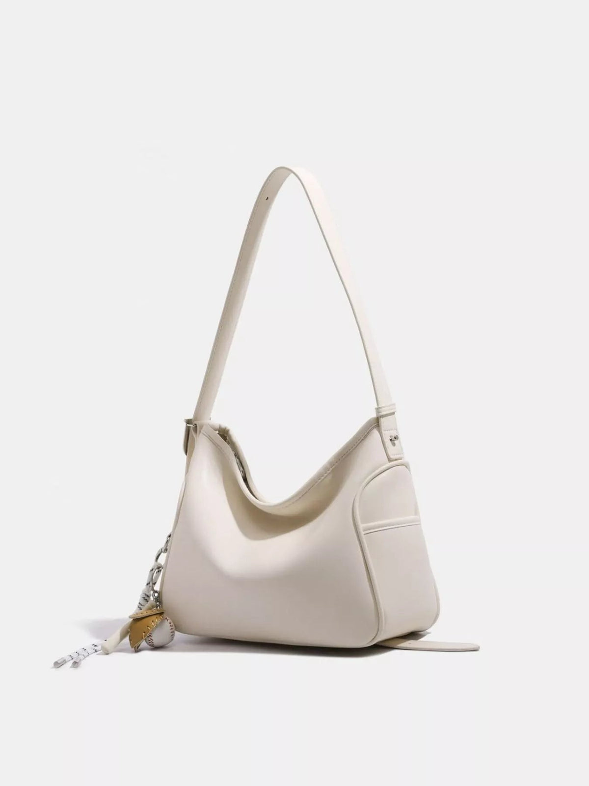 Ivory medium PU leather slouchy shoulder bag with a relaxed curved silhouette, long adjustable strap, stitched panels, and a visible side zipper.