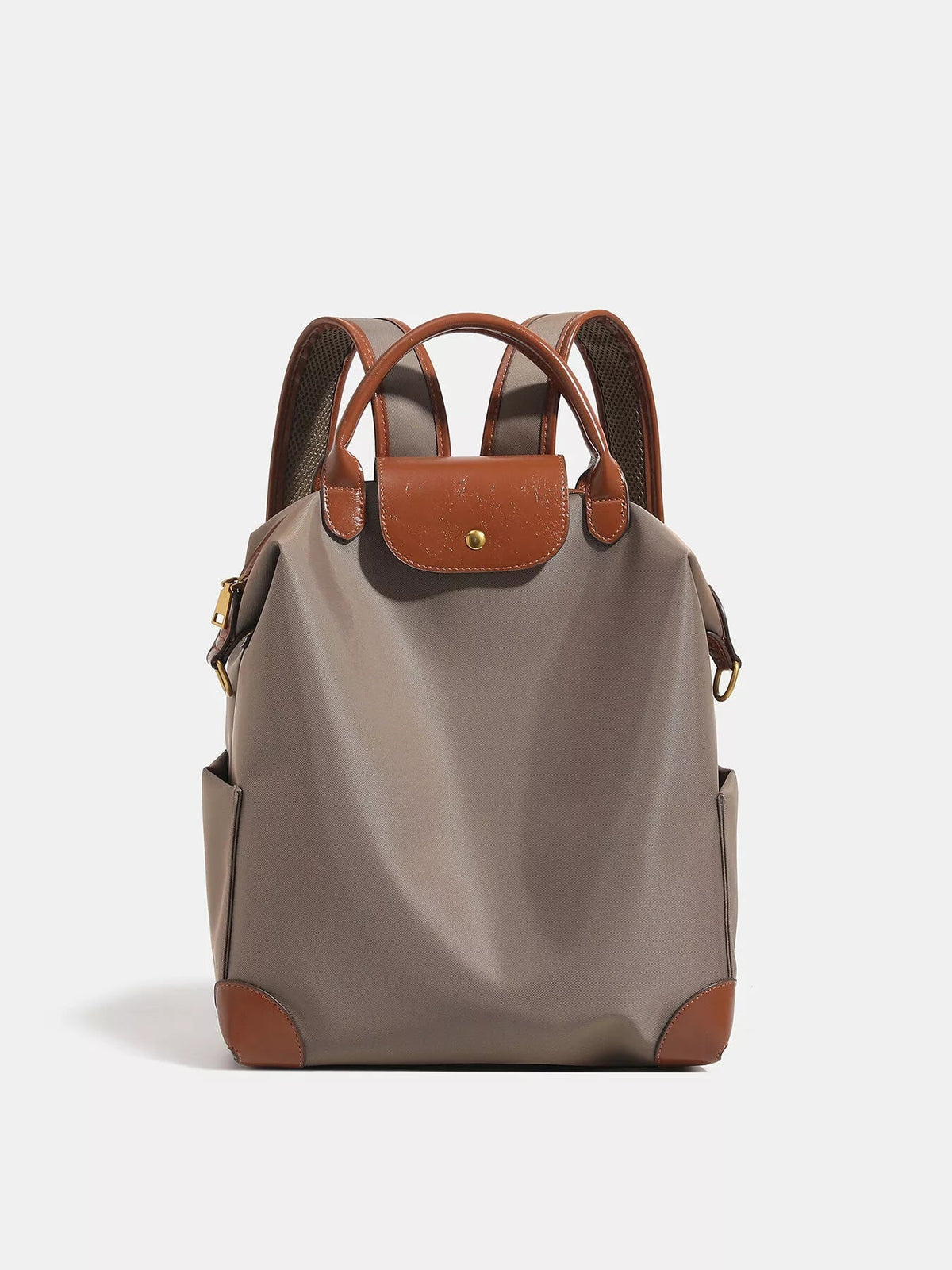 Medium taupe nylon backpack with brown faux leather trim, a rounded snap-flap pocket, padded shoulder straps, side pockets, and a structured silhouette.
