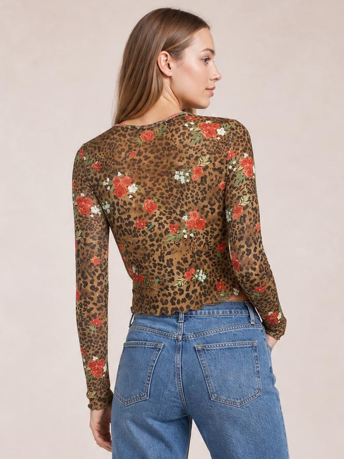 A model poses turned away in a fitted brown leopard floral mesh T-shirt with a round neck, sheer long sleeves, and a slightly cropped silhouette.