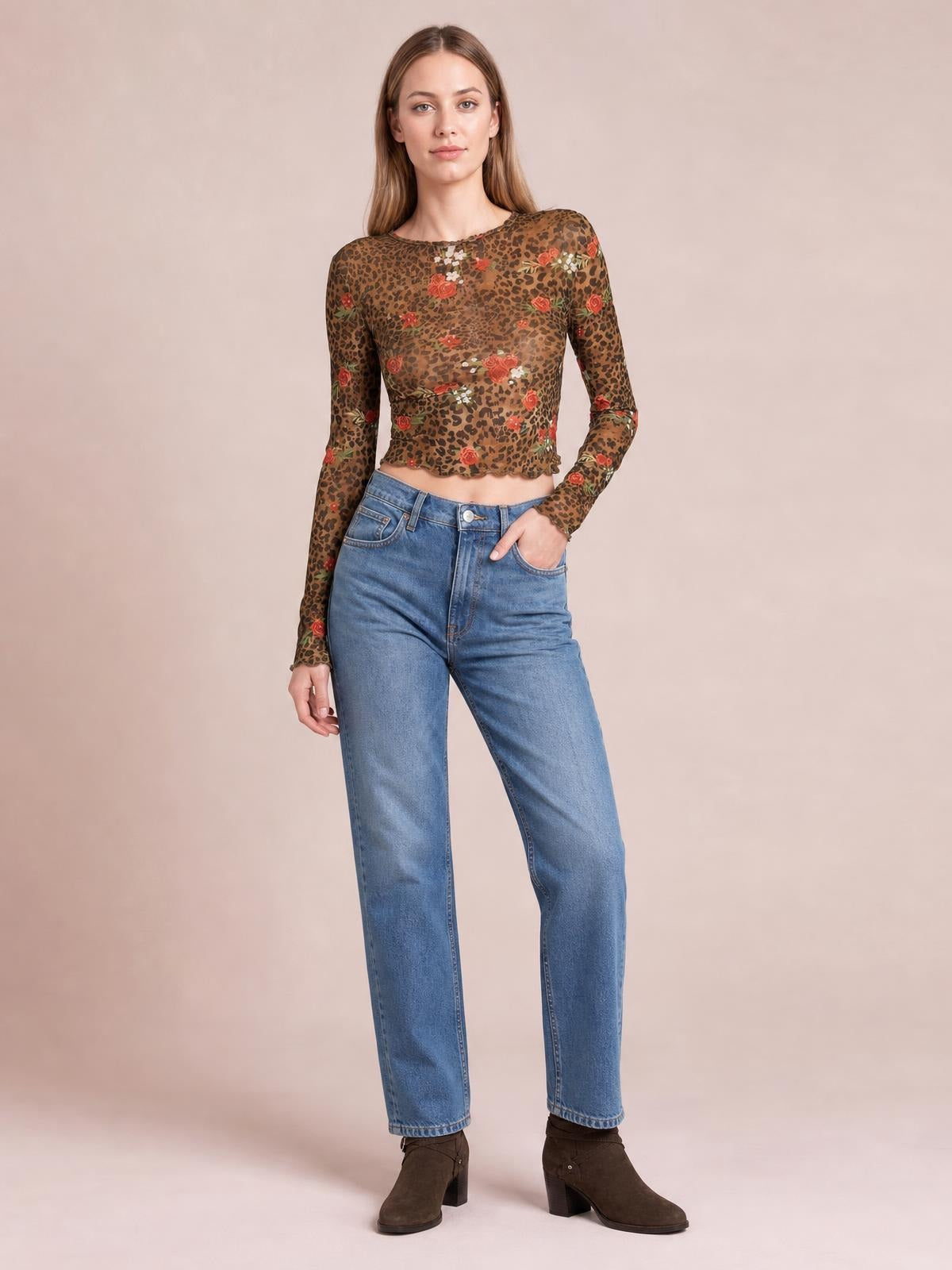 Model poses in a sheer leopard floral round neck long sleeve mesh T-shirt with a fitted cropped silhouette and slightly stretchy construction.