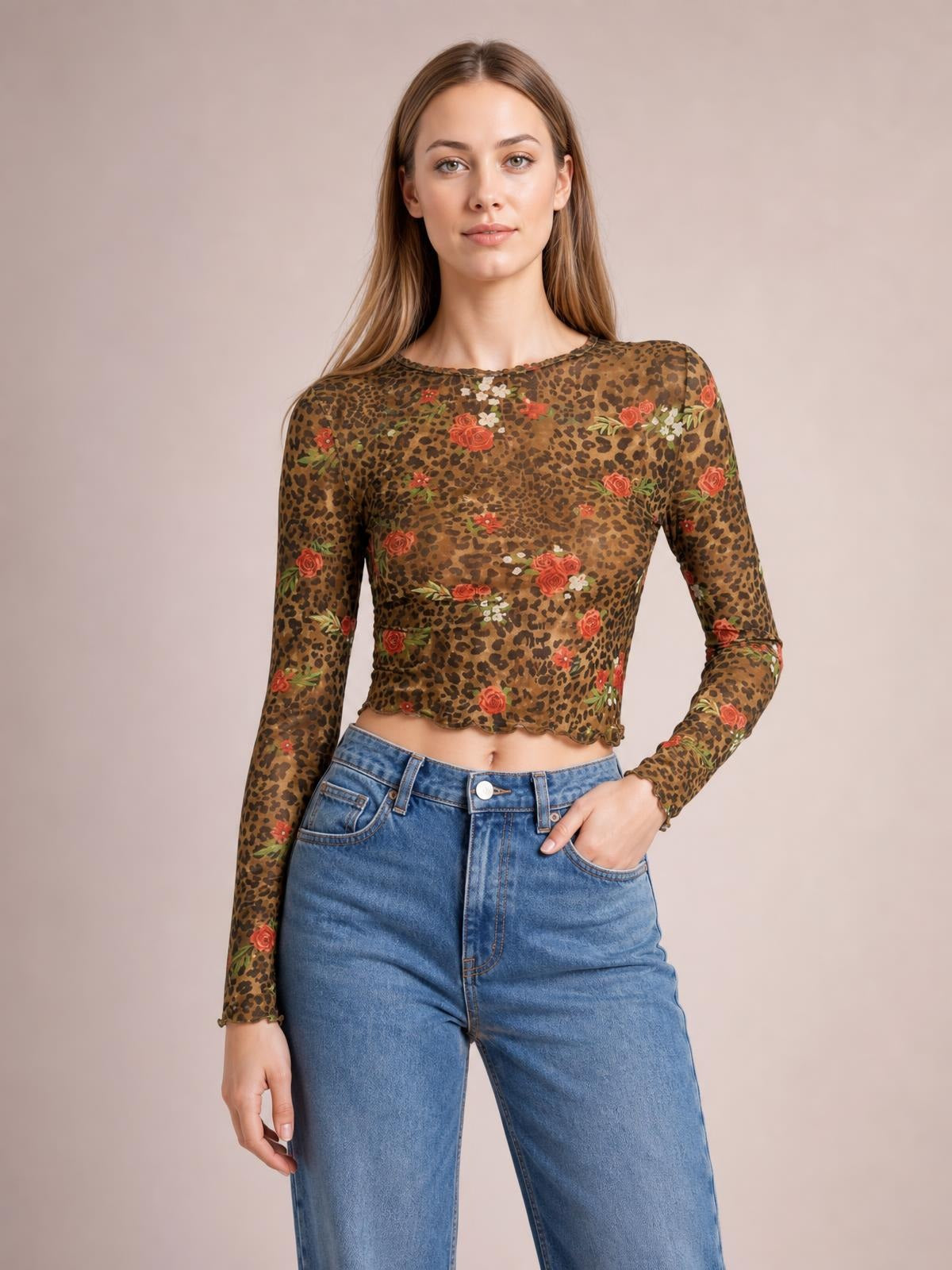Model wears a sheer brown leopard floral mesh T-shirt with a round neck, long sleeves, fitted cropped silhouette, and softly scalloped hem.