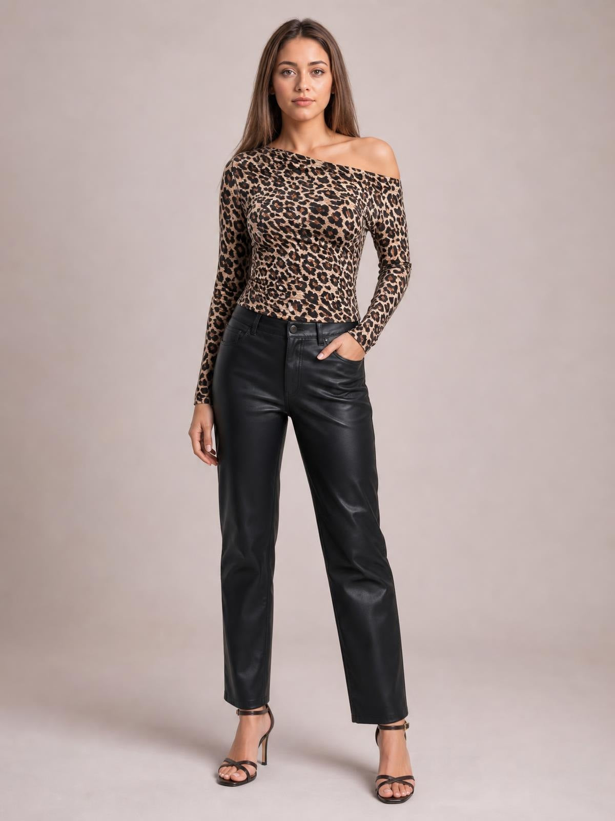 Model stands with one hand in her pocket wearing a fitted leopard-print one-shoulder long-sleeve T-shirt with an asymmetrical neckline.