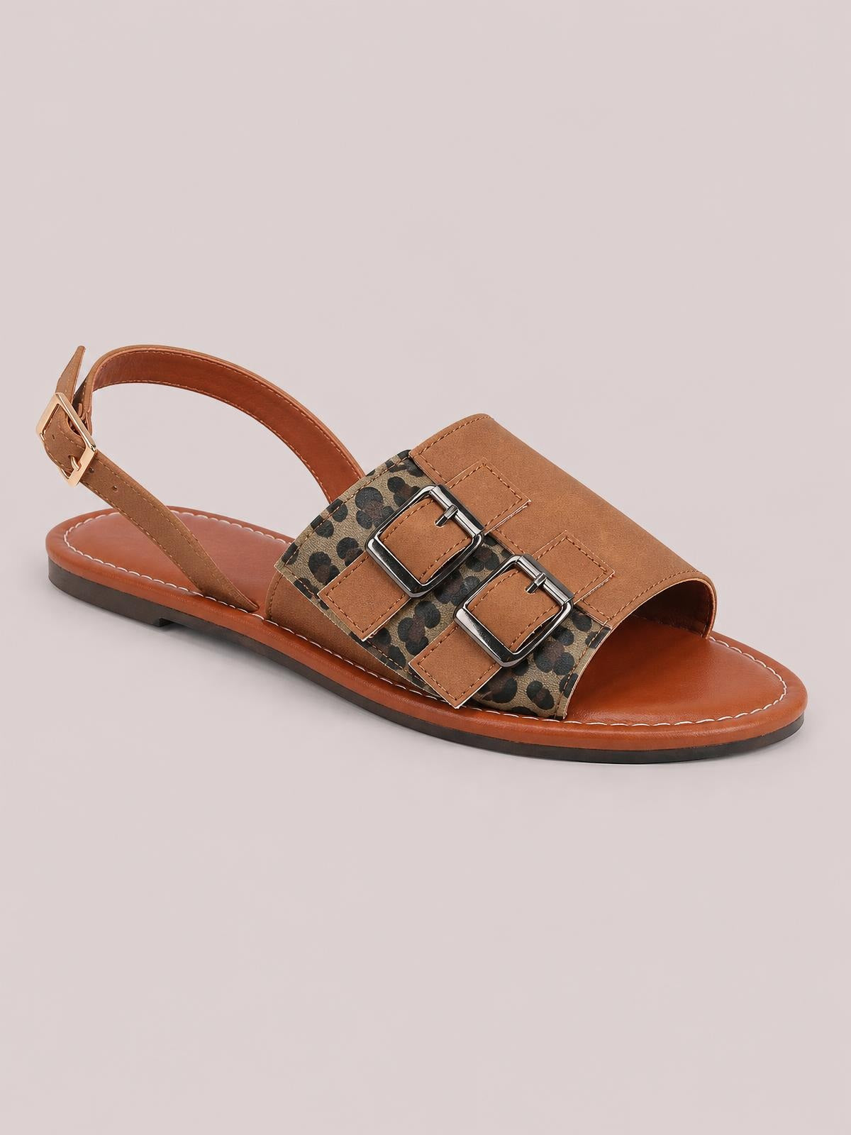 Brown leopard open toe flat sandals feature a PU leather upper, double buckle straps, an adjustable slingback ankle strap, and a low rubber sole.