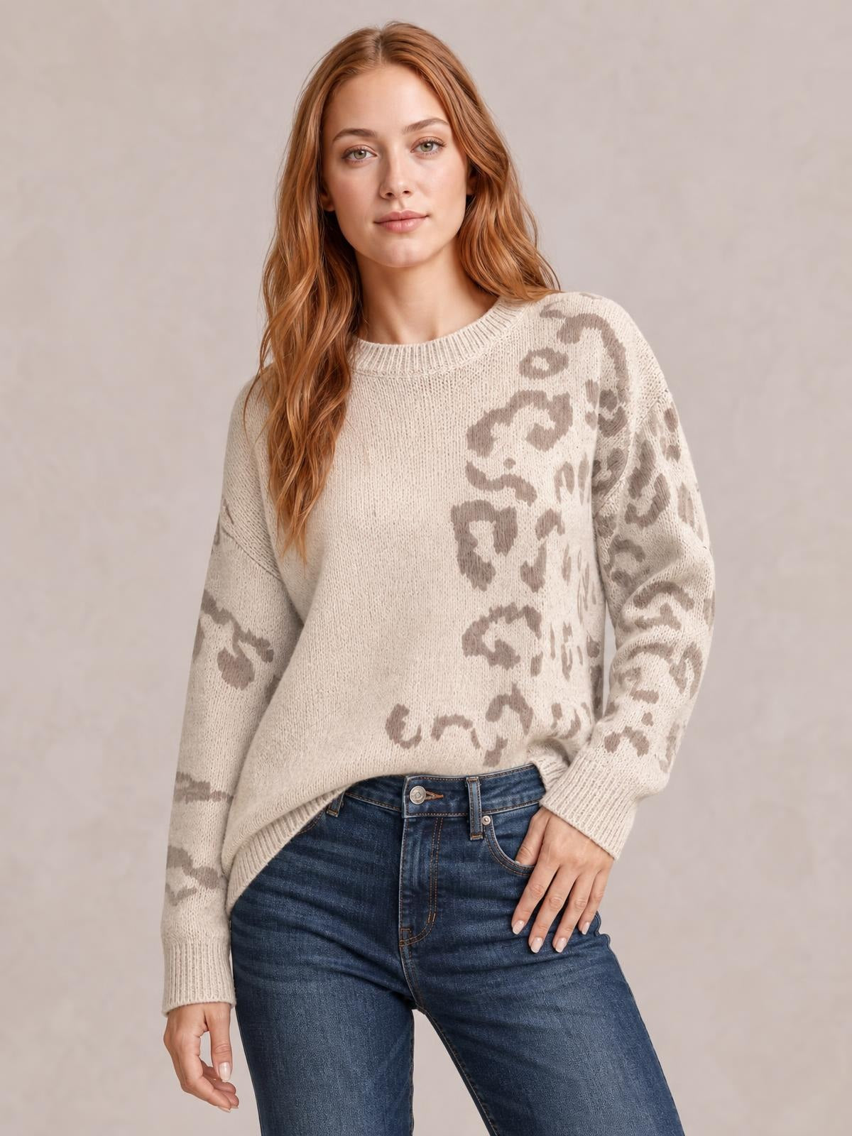 Model wears a relaxed-fit cream sweater with taupe leopard print, ribbed crew neckline, cuffs and hem, and a slightly oversized silhouette.
