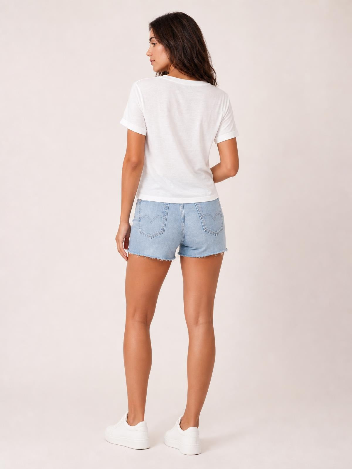 Model shown from behind in a white round-neck short-sleeve T-shirt with a simple straight silhouette, neat sleeve cuffs, and a comfortable everyday fit.