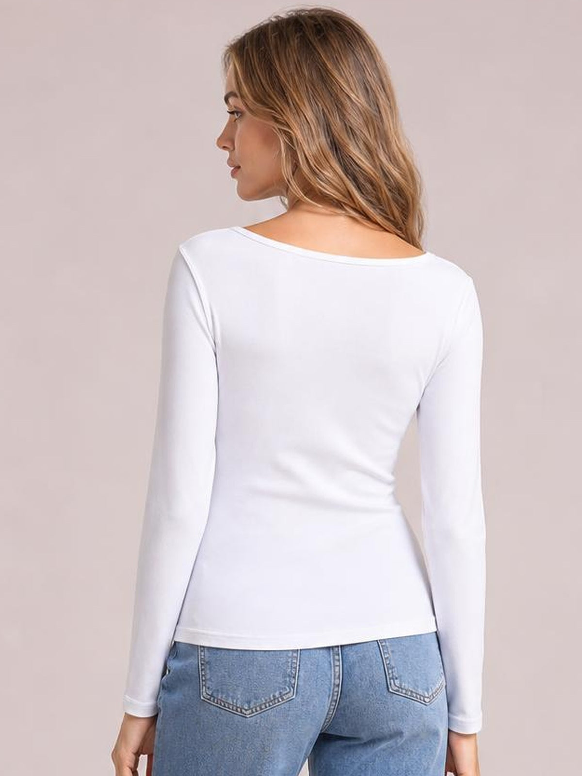 Model shown from the back in a white long sleeve scoop neck T-shirt with a close-fitting silhouette, smooth construction, and slight waist shaping.