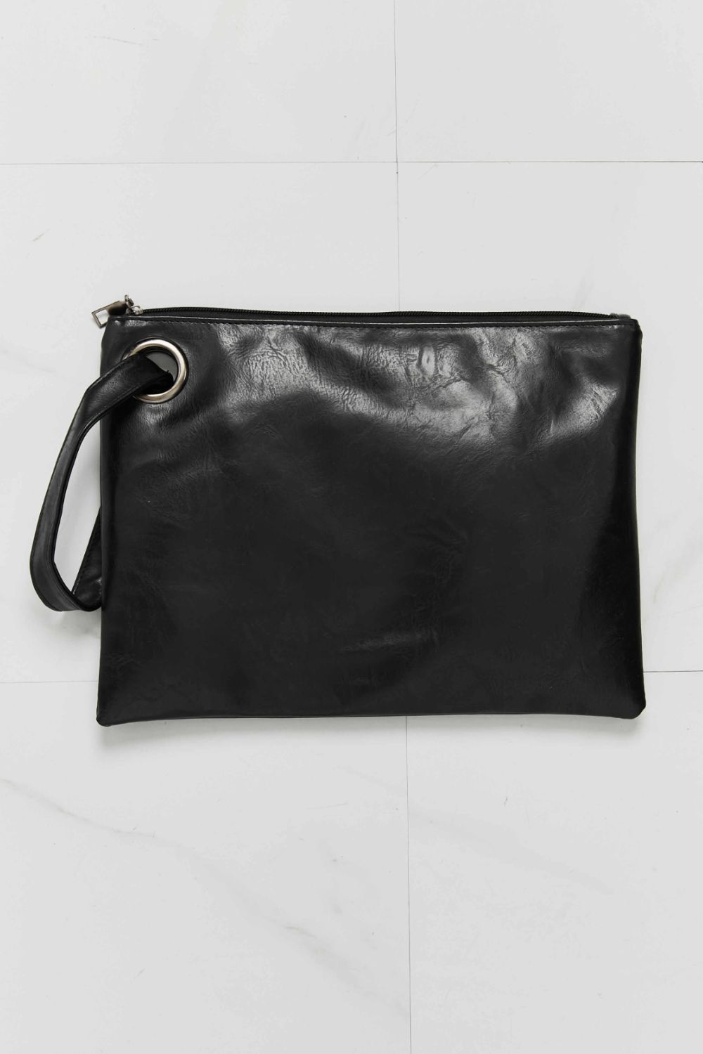 Solid black PU leather wristlet with a softly structured rectangular silhouette, top zipper closure, and attached wrist strap through a silver-tone ring.