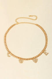 Gold alloy chain belt with a slim linked silhouette, adjustable loop closure, and dangling letter and symbolic charms for playful movement.