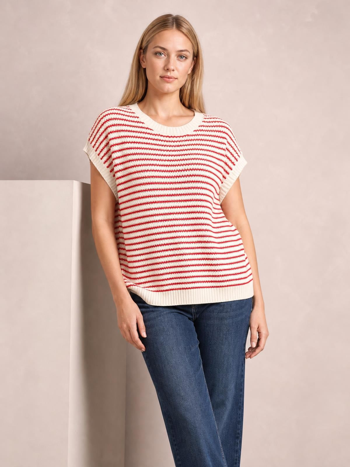 Model wearing a cream and red striped round-neck cap-sleeve sweater with ribbed neckline, cuffs, and hem in a relaxed straight silhouette.