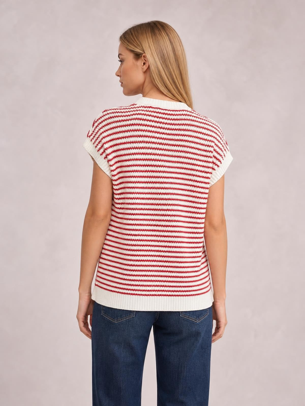 A model shows the back of a white striped round neck cap sleeve sweater with red horizontal stripes, ribbed trim, and a relaxed straight silhouette.