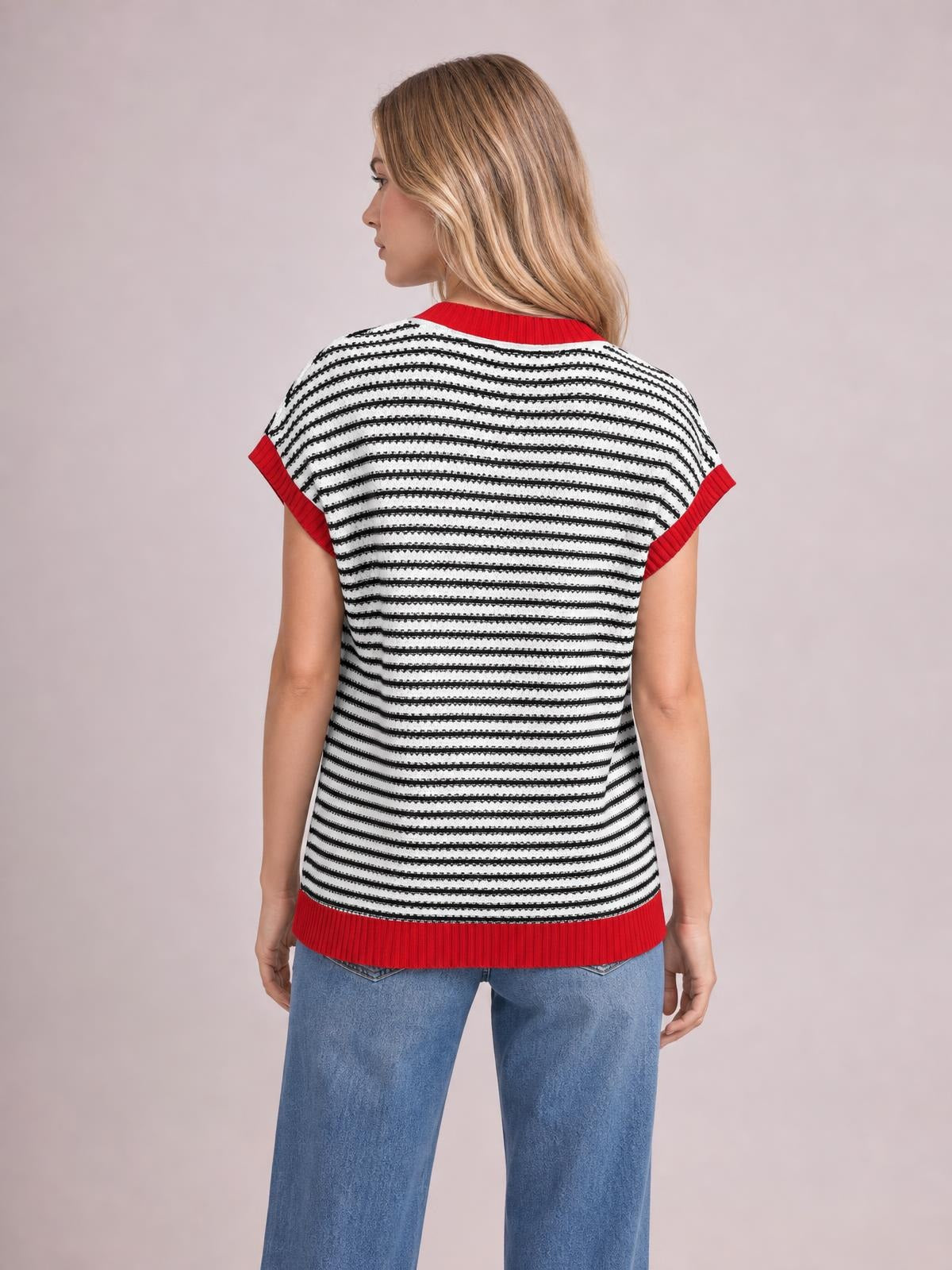 Model shown from the back wears a white and black striped round-neck cap-sleeve sweater with red ribbed trim and a relaxed silhouette.