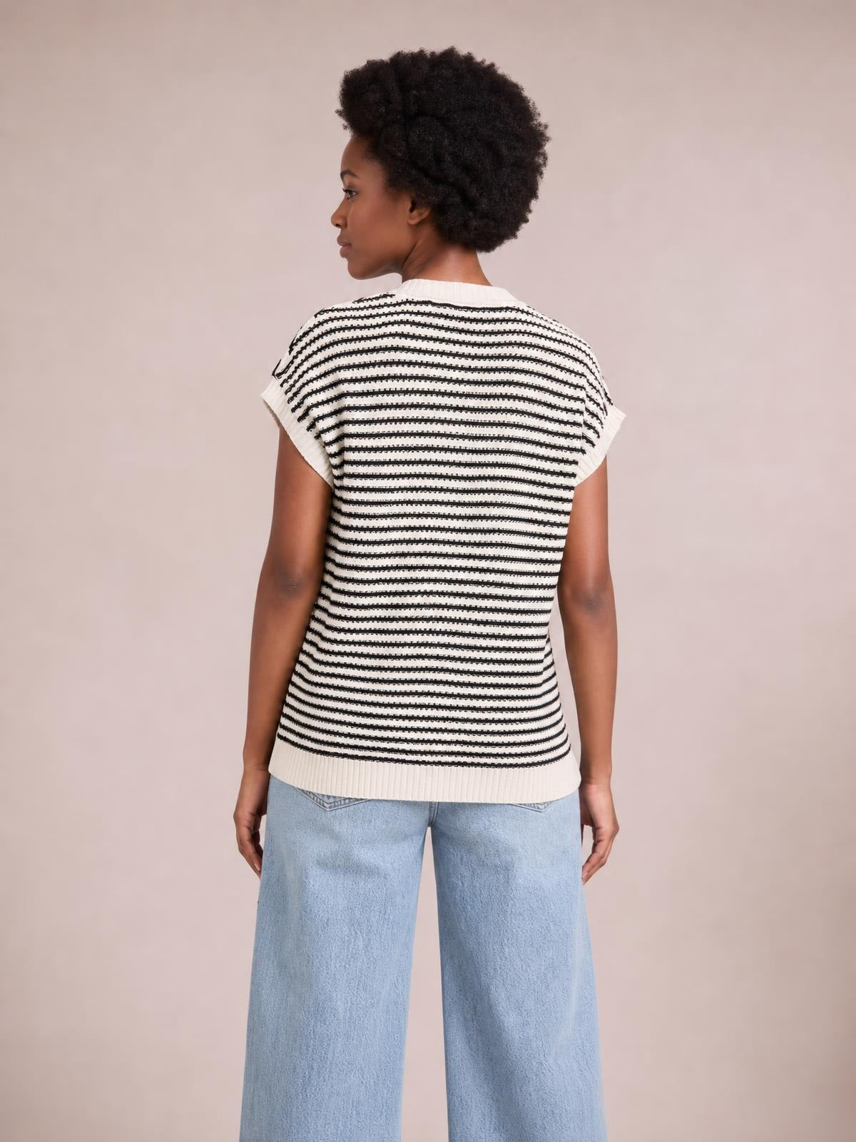 Model shown from the back wears a cream striped round-neck cap-sleeve sweater with a relaxed straight silhouette, ribbed trim, and slightly stretchy knit.