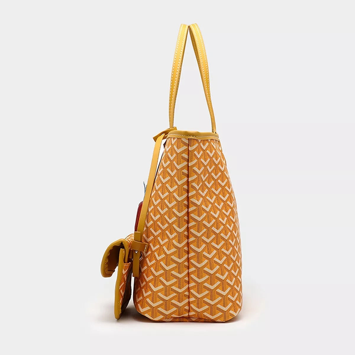 Large mustard geometric-pattern tote handbag with long shoulder straps, structured tapered silhouette, and a detachable side pouch in matching PU leather.
