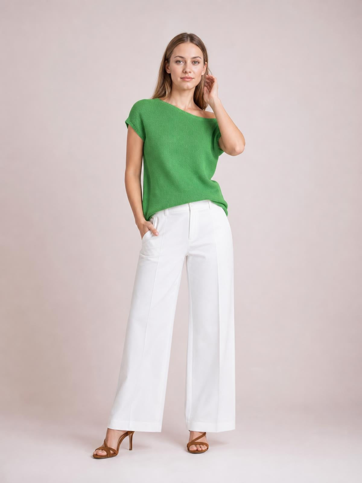 Model poses in a green boat neck short sleeve knit top with a relaxed straight silhouette, paired with white wide-leg pants.