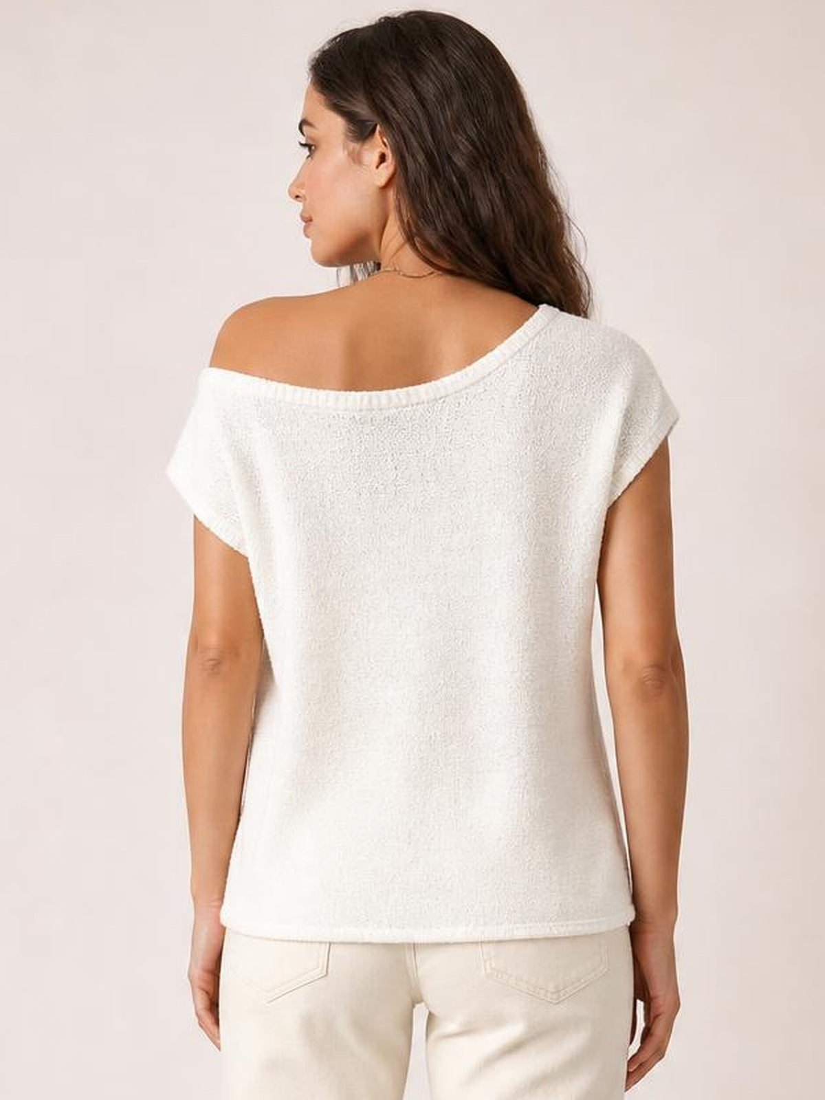 Model shown from the back wearing a white boat neck short sleeve knit top with a relaxed, straight silhouette and wide neckline.