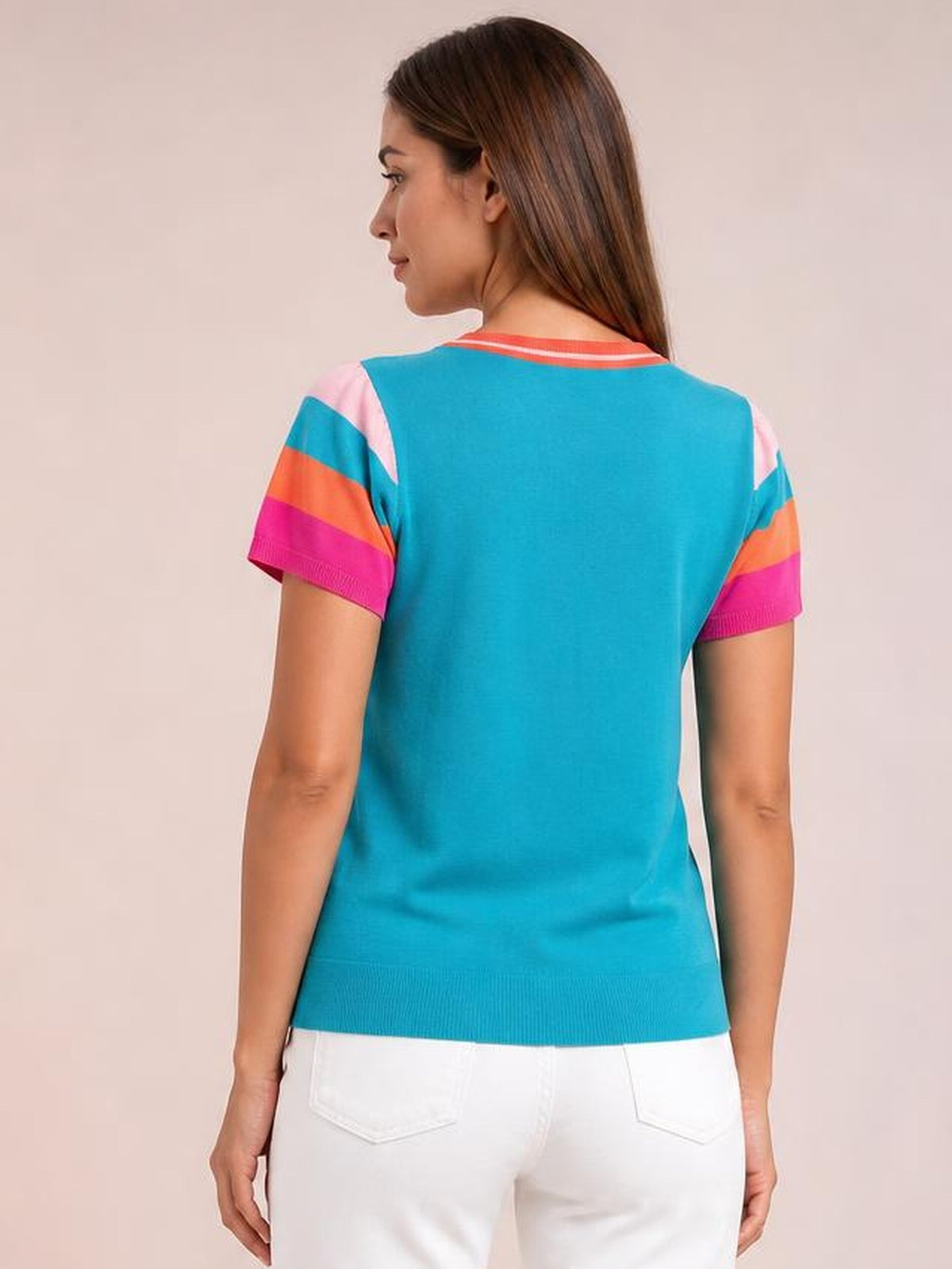 Model shown from the back wearing a turquoise contrast knit top with striped short sleeves, a round neck, straight silhouette, and ribbed hem.