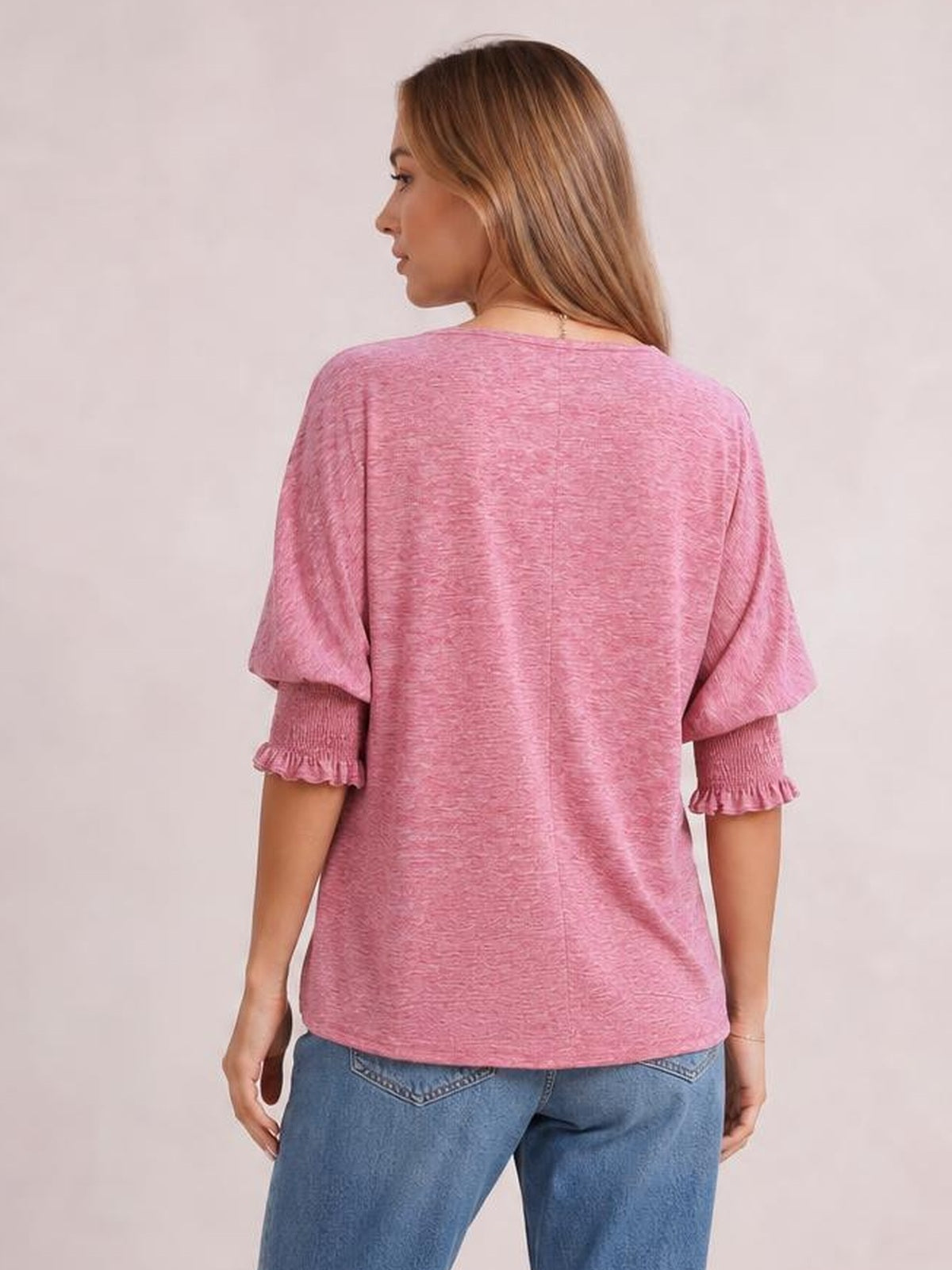 Model shown from behind in a loose pink heathered blouse with short lantern sleeves, gathered frill cuffs, and a relaxed straight silhouette.