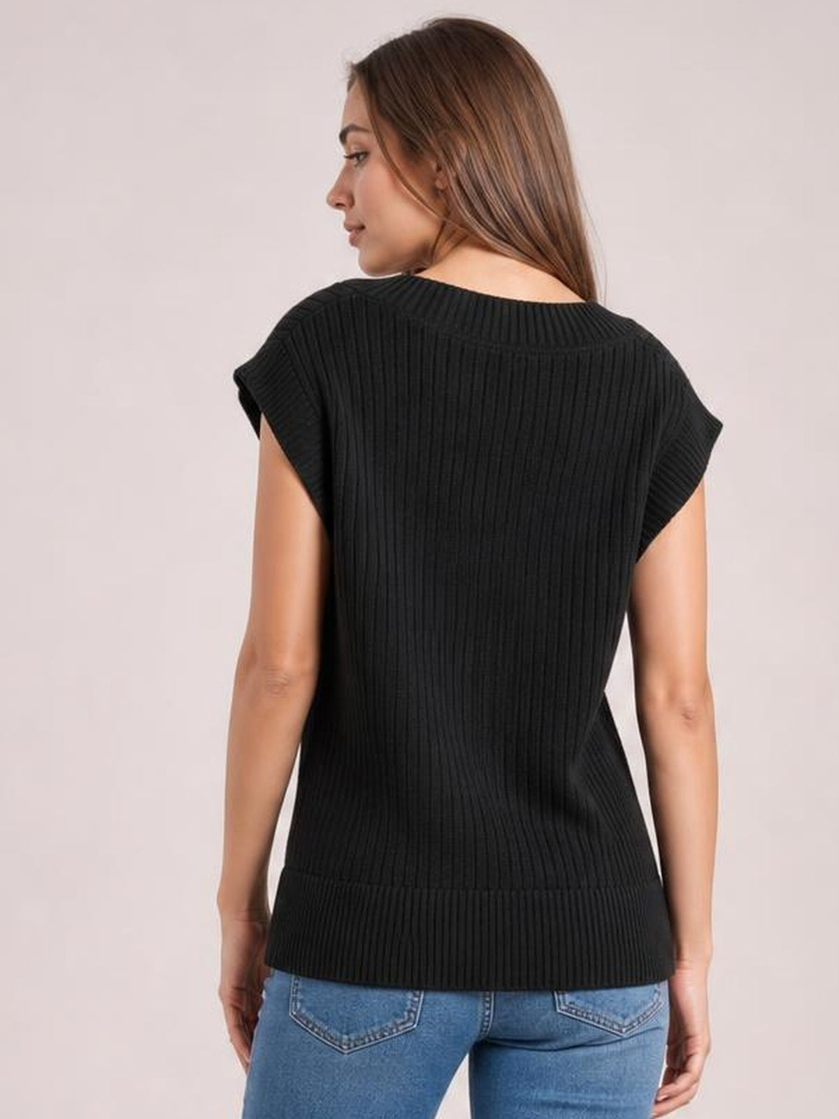 Model shown from behind wearing a black ribbed sweater vest with sleeveless construction and a relaxed, straight silhouette.
