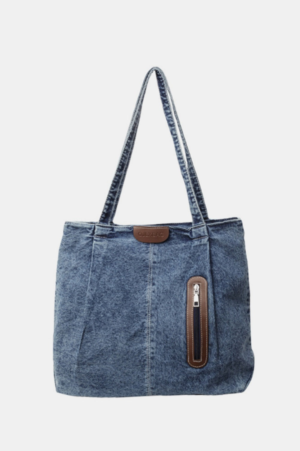 Medium blue denim tote bag with a relaxed structured silhouette, twin shoulder straps, vertical panel seams, rounded lower corners, and a front zip pocket.