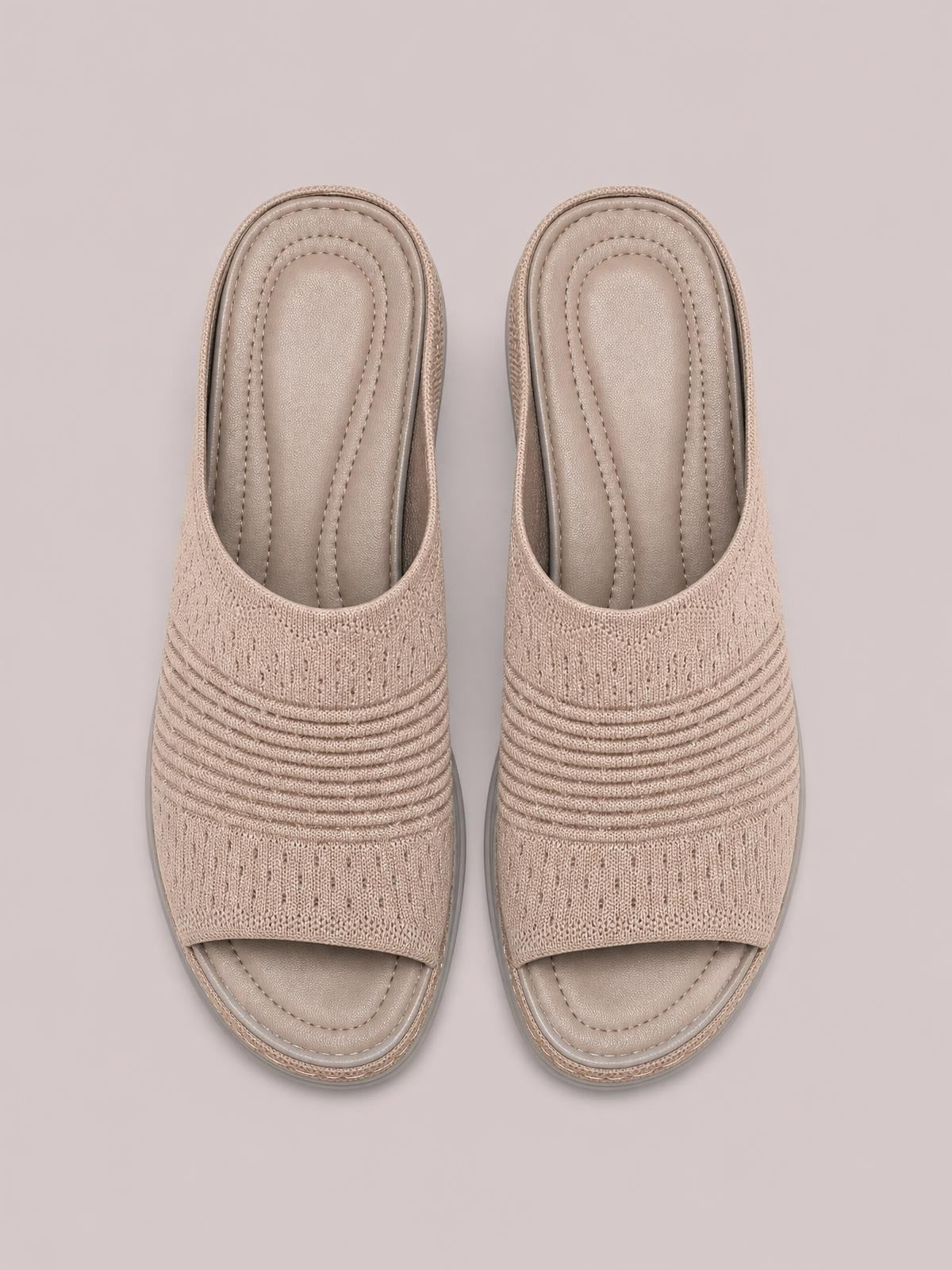 Taupe mesh open-toe flat sandals feature breathable woven uppers with ribbed detailing, cushioned stitched footbeds, and low rubber soles.