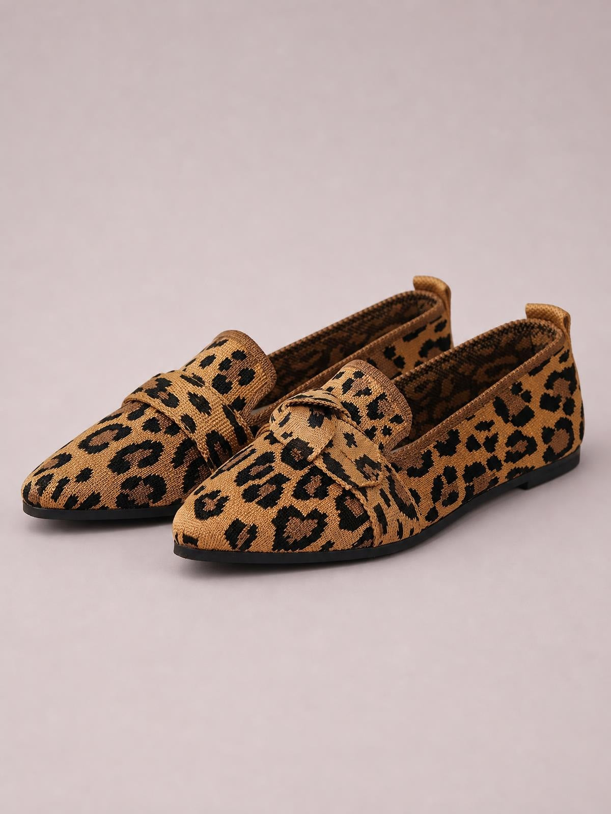 Leopard-print mesh point-toe flat slip-ons feature a loafer-inspired vamp strap and slim black rubber soles.
