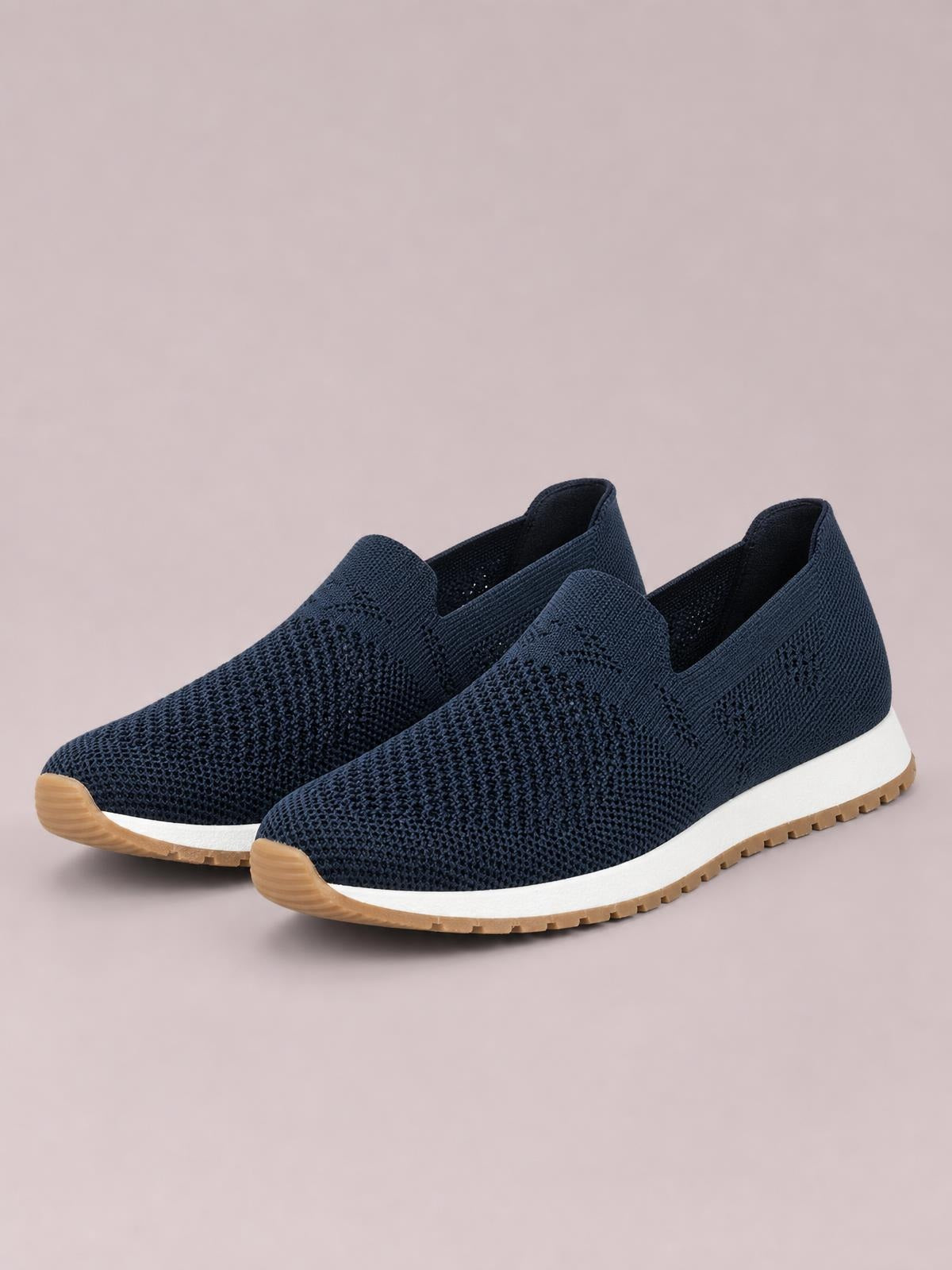 Navy mesh round-toe flat slip-on shoes feature a streamlined low-top silhouette, textured knit construction, white midsoles, and gum rubber outsoles.