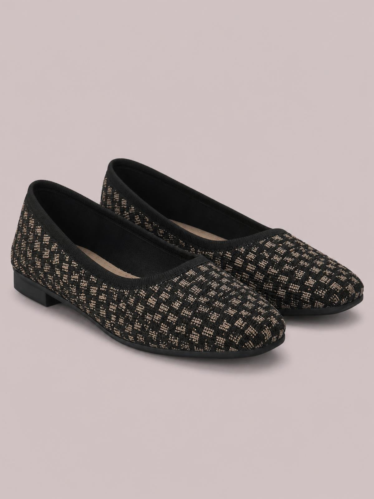Black mesh round-toe flat slip-ons feature a beige woven pattern, low rubber soles, and an easy slip-on construction.