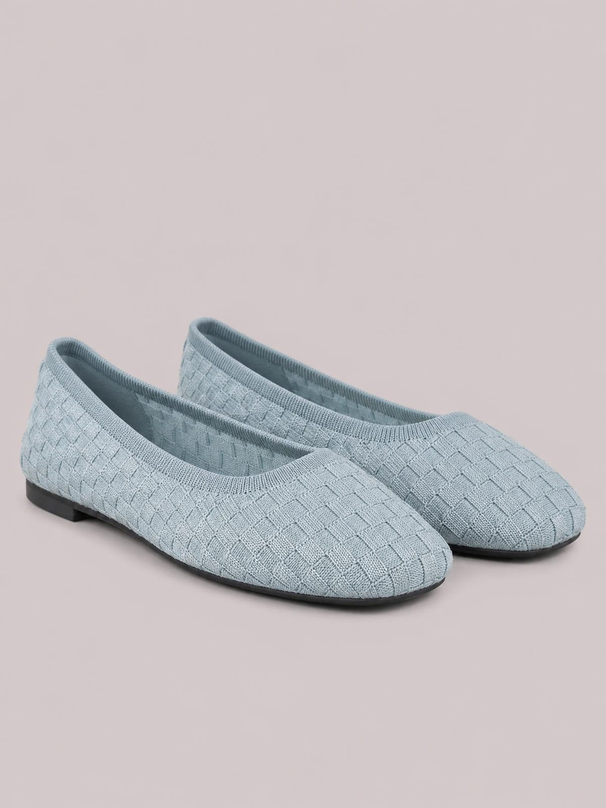 Light blue mesh round-toe flat slip-ons feature a woven textured upper, elastic openings, and slim black rubber soles.