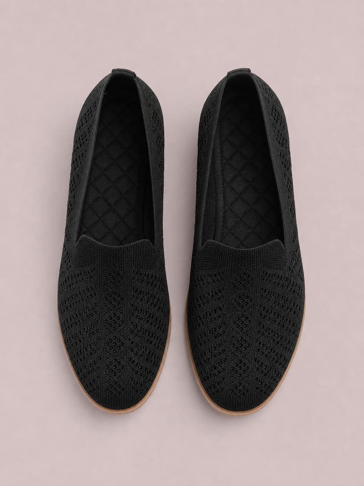 Black mesh round-toe flat slip-on shoes feature a streamlined silhouette, textured uppers, easy openings, and contrasting rubber soles.
