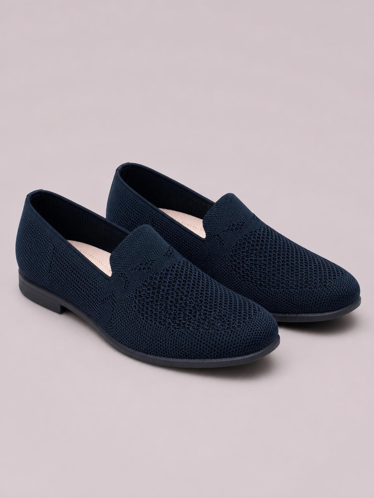 Navy mesh round-toe flat slip-ons feature breathable woven uppers, easy slip-on openings, and low-profile rubber soles for a streamlined silhouette.