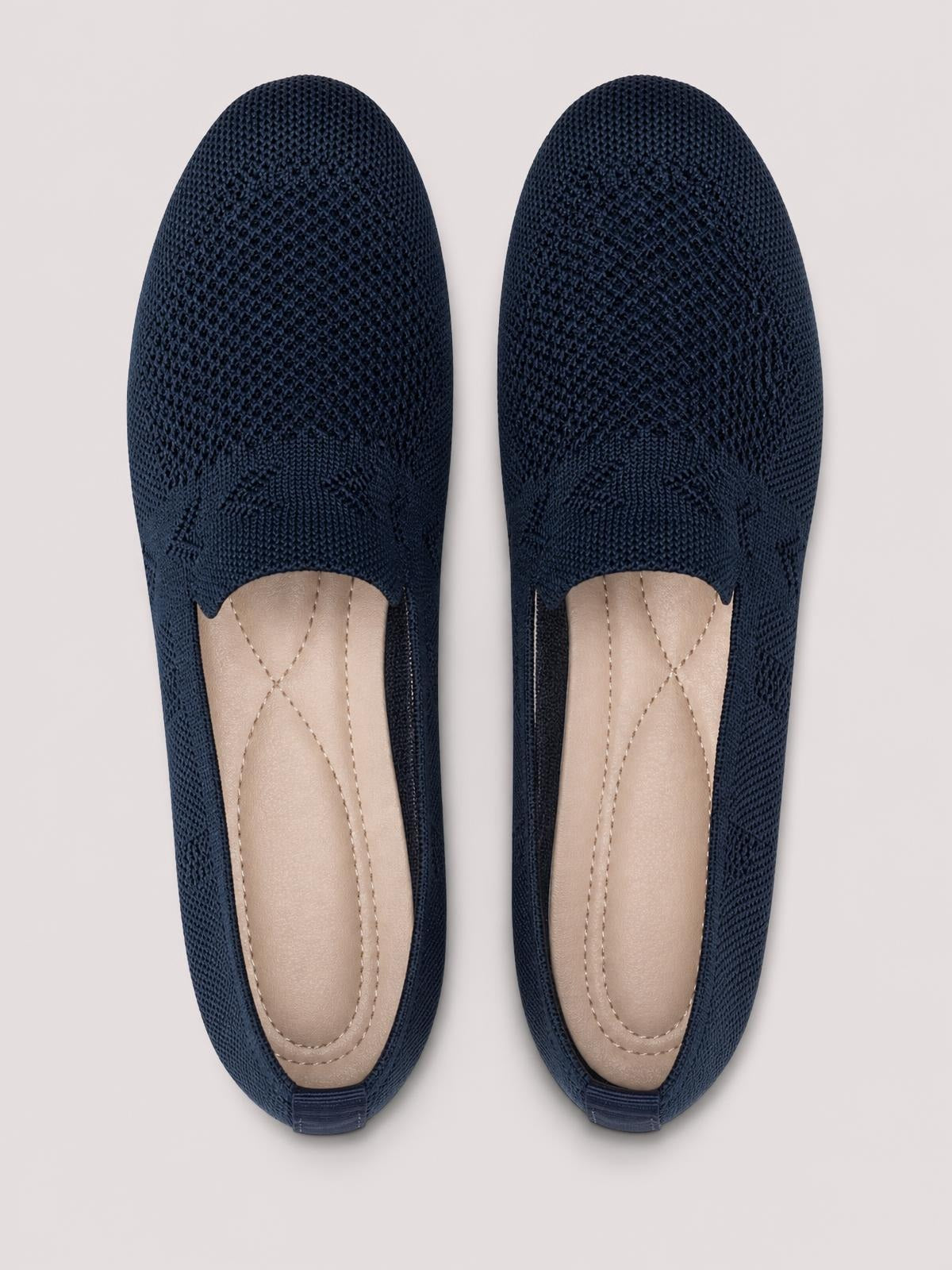 Navy mesh round-toe flat slip-ons with a low-profile silhouette, open vamp, cushioned beige insoles, and flexible rubber soles.