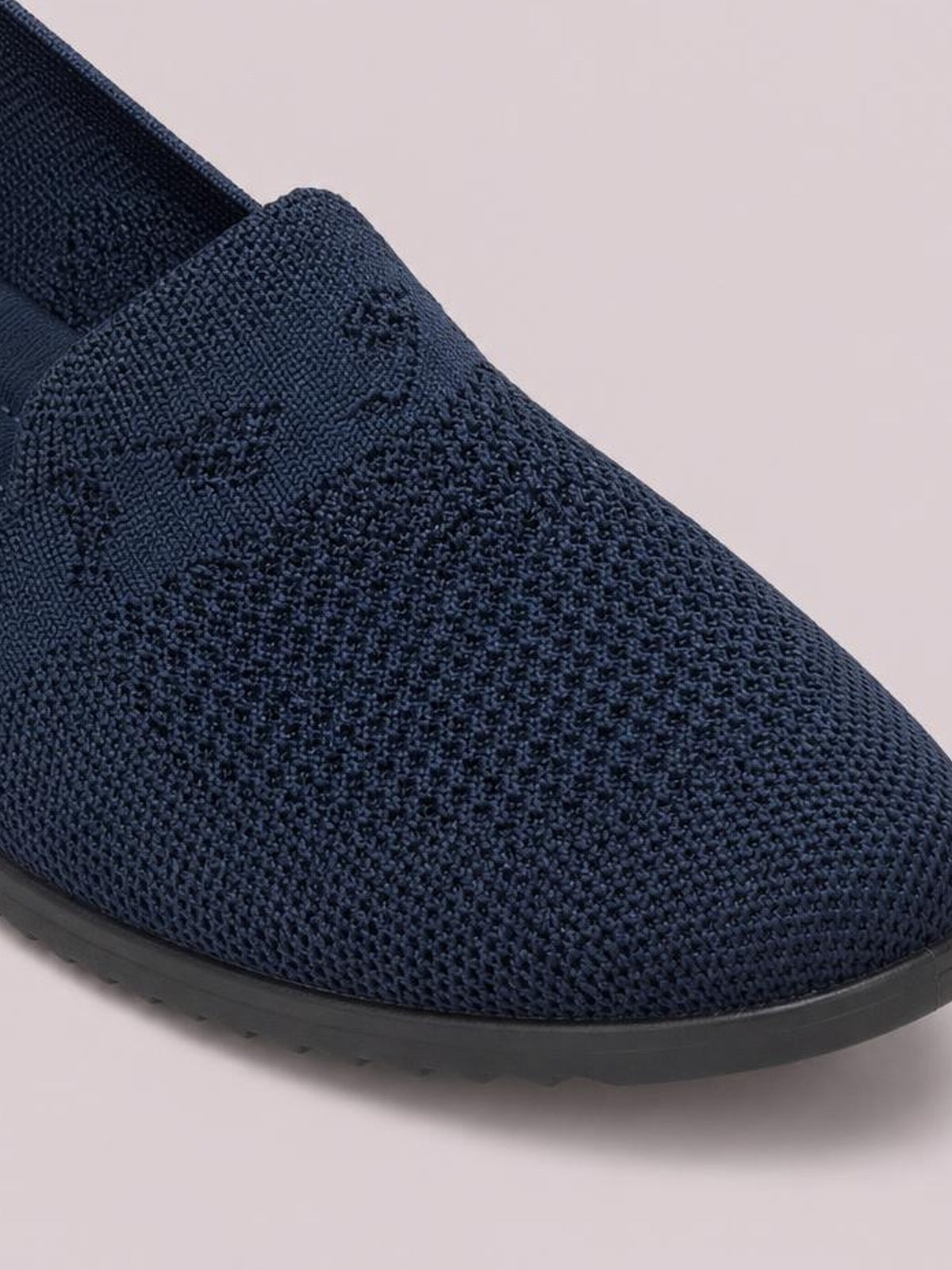 Navy mesh round-toe flat slip-on with a textured knit upper, seamless construction, and a low-profile black rubber sole.