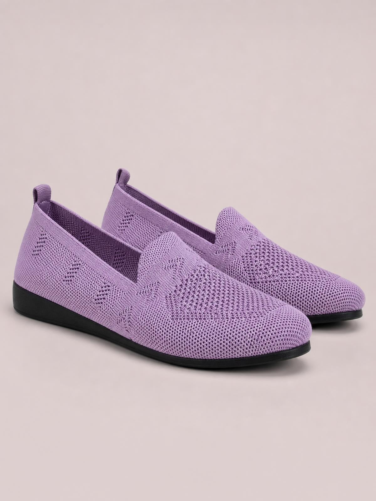 Lavender mesh round-toe flat slip-ons feature textured knit uppers, easy slip-on openings, black rubber soles, and streamlined low-profile silhouettes.