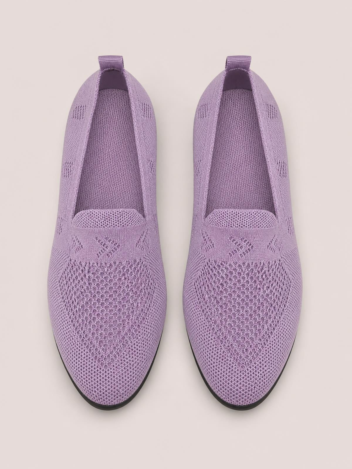 Lavender mesh round-toe flat slip-ons with breathable knit-textured uppers, easy pull tabs, and slim black rubber soles.