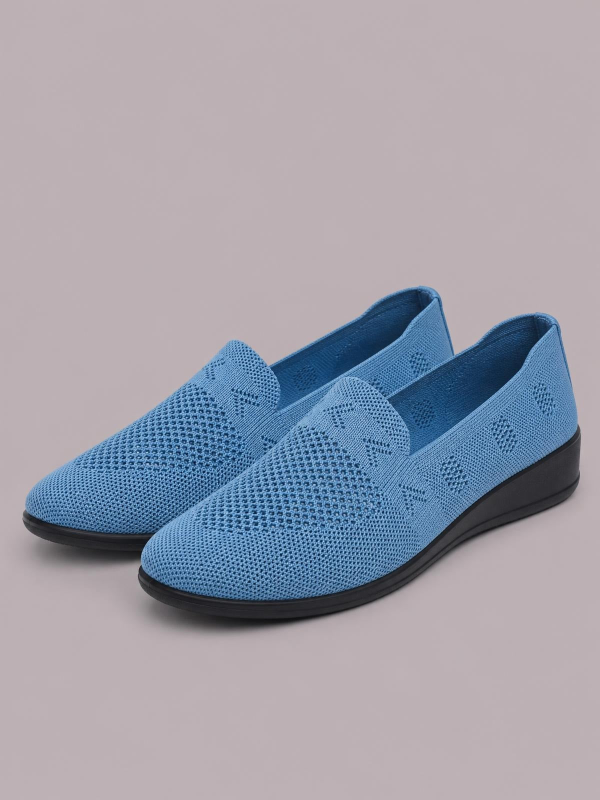 Blue mesh round-toe flat slip-ons feature a breathable perforated upper, easy slip-on construction, and a contrasting black rubber sole.
