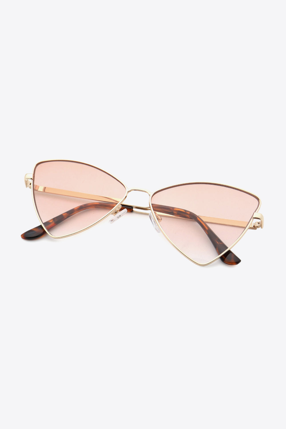 Metal frame cat-eye sunglasses feature slim gold-toned frames, softly pink-tinted lenses, and tortoiseshell-inspired metal-plastic hybrid temples.
