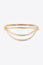 Gold-tone triple-layered chain belt with a slim upper band and three cascading linked chains forming a graceful draped silhouette.