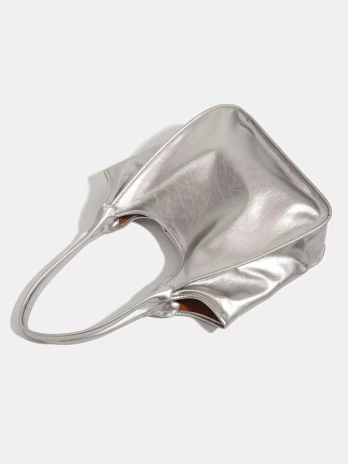 Metallic silver PU leather tote bag with a medium slouchy silhouette, wide open top, reinforced seams, and long matching shoulder straps.