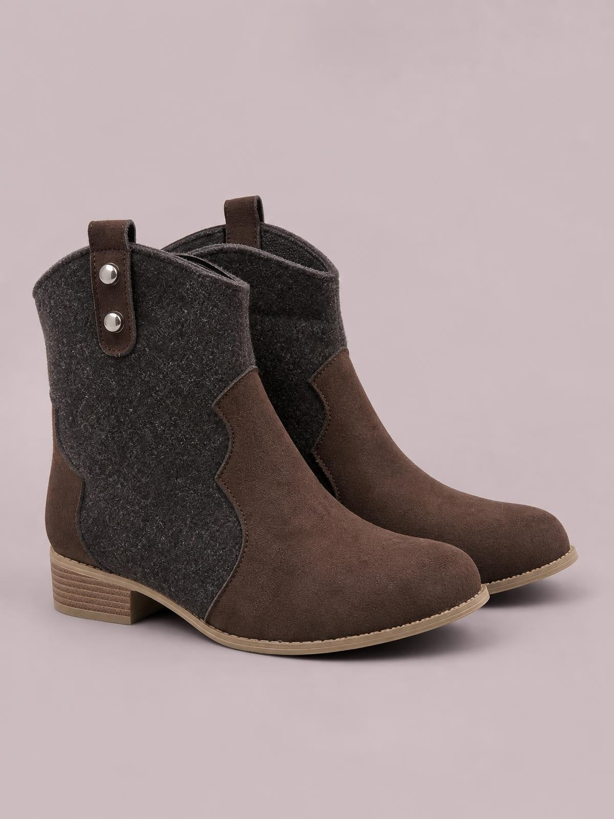 Brown mid-calf western boots feature dark contrast side panels, pull tabs, rounded toes, stitched construction, and sturdy low block heels.
